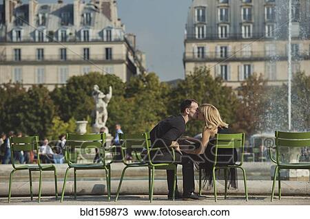 Caucasian couple kissing near fountain in urban park, Paris, Ile-de-France, France View Large Photo Image Stock Image - Caucasian couple kissing near fountain in urban park, Paris, Ile-de-France, France. Fotosearch