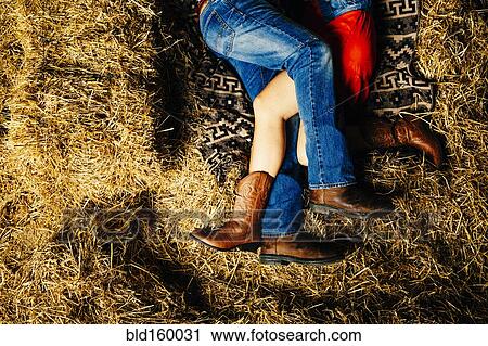Caucasian couple laying on haystacks View Large Photo Image Stock Image - Caucasian couple laying on haystacks. Fotosearch