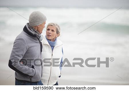 Caucasian couple walking on beach View Large Photo Image Stock Image - Caucasian couple walking on beach. Fotosearch
