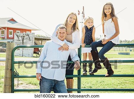 Caucasian family smiling on farm View Large Photo Image Stock Image - Caucasian family smiling on farm. Fotosearch