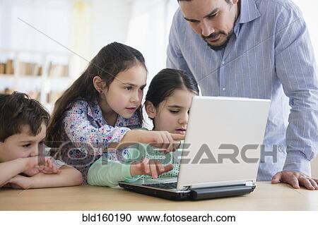 Caucasian father and children using laptop View Large Photo Image Stock Image - Caucasian father and children using laptop. Fotosearch
