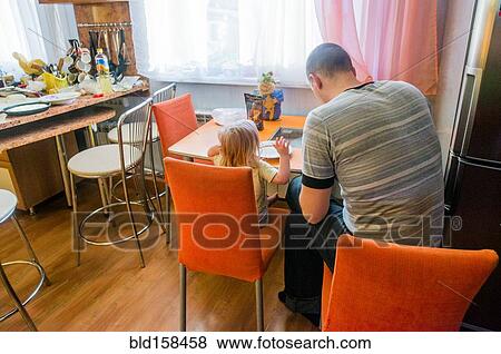 Caucasian father and daughter sitting in kitchen View Large Photo Image Stock Photo - Caucasian father and daughter sitting in kitchen. Fotosearch