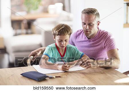 Caucasian father and son drawing at table View Large Photo Image Stock Image - Caucasian father and son drawing at table. Fotosearch