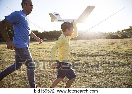 Caucasian father and son flying model airplane in field View Large Photo Image Stock Image - Caucasian father and son flying model airplane in field. Fotosearch