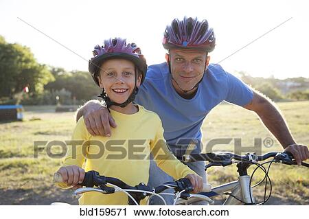 Caucasian father and son riding bicycles View Large Photo Image Stock Image - Caucasian father and son riding bicycles. Fotosearch