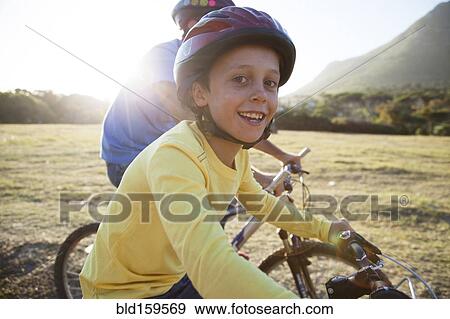 Caucasian father and son riding bicycles View Large Photo Image Stock Photo - Caucasian father and son riding bicycles. Fotosearch