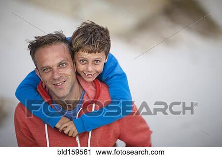 Caucasian father carrying son piggyback outdoors View Large Photo Image Stock Image - Caucasian father carrying son piggyback outdoors. Fotosearch