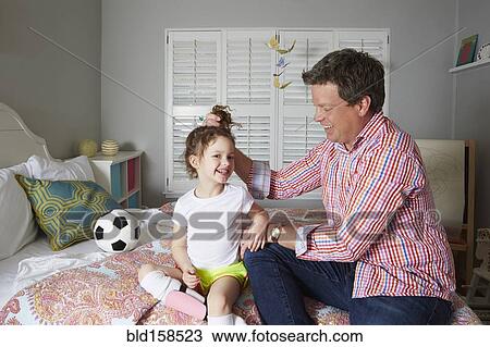 Caucasian father holding hair of daughter View Large Photo Image Stock Image - Caucasian father holding hair of daughter. Fotosearch