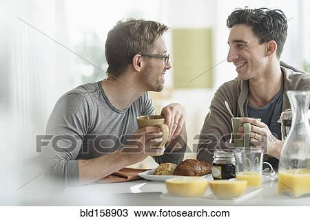Caucasian gay couple eating breakfast together View Large Photo Image Stock Image - Caucasian gay couple eating breakfast together. Fotosearch
