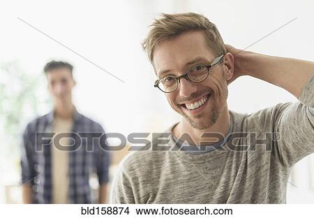 Caucasian gay couple smiling in home View Large Photo Image Picture - Caucasian gay couple smiling in home. Fotosearch