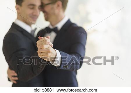 Caucasian gay grooms dancing at wedding View Large Photo Image Stock Image - Caucasian gay grooms dancing at wedding. Fotosearch