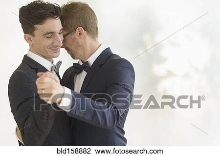 Caucasian gay grooms dancing at wedding View Large Photo Image Stock Image - Caucasian gay grooms dancing at wedding. Fotosearch