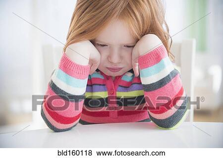 Caucasian girl crying at table View Large Photo Image Stock Photo - Caucasian girl crying at table. Fotosearch