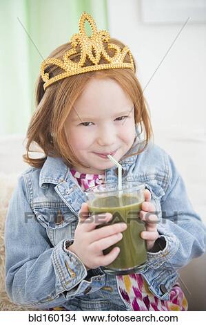 Caucasian girl drinking healthy juice View Large Photo Image Picture - Caucasian girl drinking healthy juice. Fotosearch