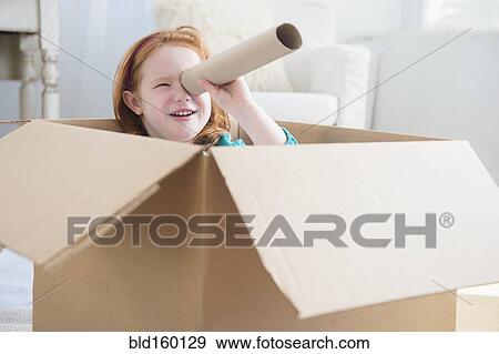 Caucasian girl playing in cardboard box View Large Photo Image Stock Photo - Caucasian girl playing in cardboard box. Fotosearch