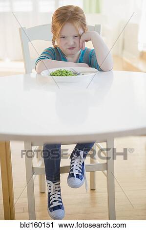 Caucasian girl pouting at plate of vegetables View Large Photo Image Stock Image - Caucasian girl pouting at plate of vegetables. Fotosearch
