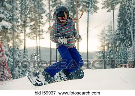 Caucasian girl riding snowboard in snow View Large Photo Image Stock Photo - Caucasian girl riding snowboard in snow. Fotosearch