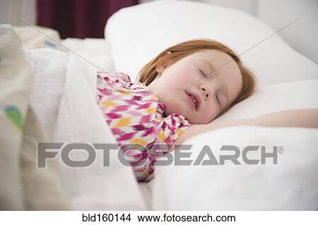 Picture - Caucasian girl sleeping in bed. Fotosearch