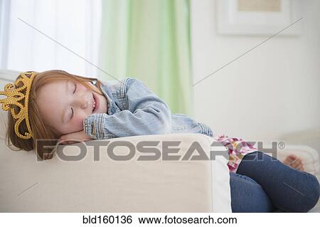 Stock Photograph - Caucasian girl wearing tiara in armchair. Fotosearch