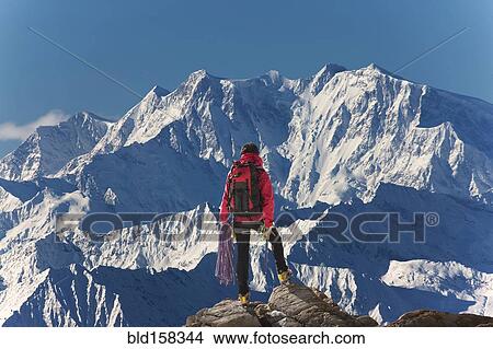 Picture - Caucasian hiker admiring scenic view from mountaintop, Monte Rosa, Alps, Italy. Fotosearch