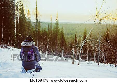 Caucasian hiker admiring scenic view from snowy hillside View Large Photo Image Stock Photo - Caucasian hiker admiring scenic view from snowy hillside. Fotosearch