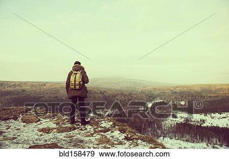 Caucasian hiker admiring scenic view from snowy mountaintop View Large Photo Image Stock Photo - Caucasian hiker admiring scenic view from snowy mountaintop. Fotosearch