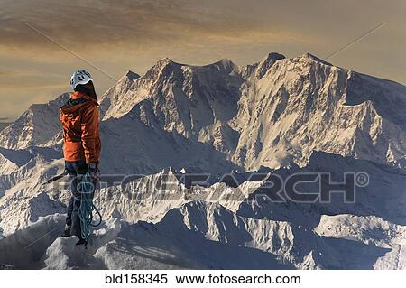 Stock Photography - Caucasian hiker admiring scenic view from mountaintop, Monte Rosa, Alps, Italy. Fotosearch
