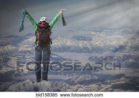 Stock Photography - Caucasian hiker cheering on mountaintop, Monte Rosa, Alps, Italy. Fotosearch