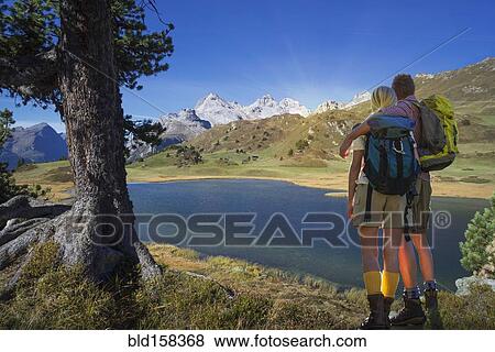 Caucasian hikers admiring remote lake, Lai da Vons, Canton Graubunden, Switzerland View Large Photo Image Stock Photo - Caucasian hikers admiring remote lake, Lai da Vons, Canton Graubunden, Switzerland. Fotosearch