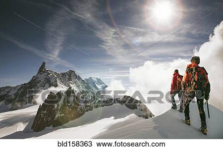 Caucasian hikers standing on snowy mountain top, Mont Blanc, Alps, France View Large Photo Image Stock Image - Caucasian hikers standing on snowy mountain top, Mont Blanc, Alps, France. Fotosearch