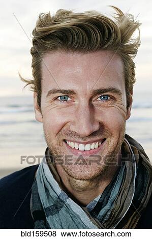 Caucasian man smiling on beach View Large Photo Image Stock Photo - Caucasian man smiling on beach. Fotosearch