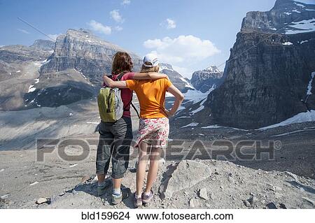 Caucasian mother and daughter admiring scenic view of Six Glaciers Trail, Banff, Alberta, Canada View Large Photo Image Picture - Caucasian mother and daughter admiring scenic view of Six Glaciers Trail, Banff, Alberta, Canada. Fotosearch
