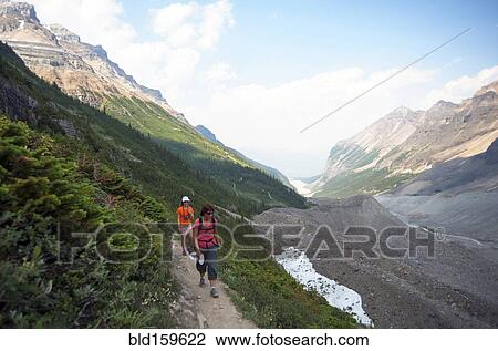 Stock Image - Caucasian mother and daughter hiking on Six Glaciers Trail, Banff, Alberta, Canada. Fotosearch