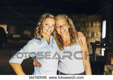 Caucasian mother and daughter hugging View Large Photo Image Stock Photograph - Caucasian mother and daughter hugging. Fotosearch