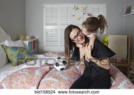 Caucasian mother and daughter kissing in bedroom View Large Photo Image Picture - Caucasian mother and daughter kissing in bedroom. Fotosearch