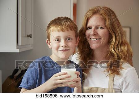 Caucasian mother and son drinking milk in kitchen View Large Photo Image Stock Photograph - Caucasian mother and son drinking milk in kitchen. Fotosearch