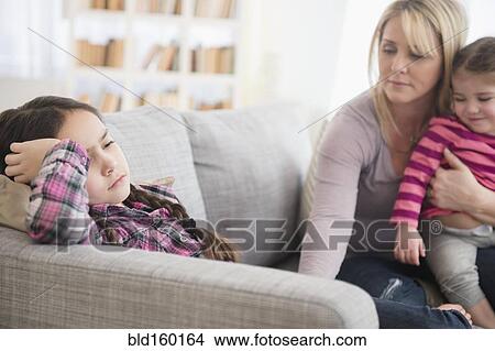 Caucasian mother comforting upset daughter on sofa View Large Photo Image Picture - Caucasian mother comforting upset daughter on sofa. Fotosearch