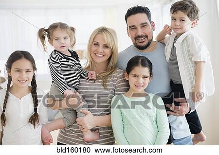 Stock Image - Caucasian parents and children smiling. Fotosearch