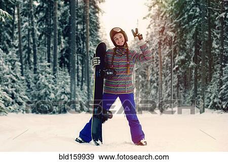 Caucasian snowboarder making peace sign in snowy forest View Large Photo Image Stock Photo - Caucasian snowboarder making peace sign in snowy forest. Fotosearch
