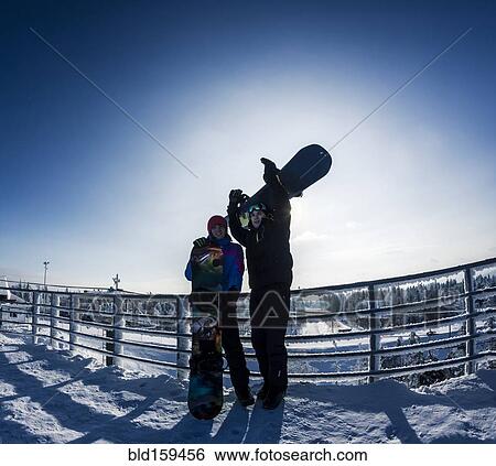 Caucasian snowboarders standing on snowy mountaintop View Large Photo Image Stock Photograph - Caucasian snowboarders standing on snowy mountaintop. Fotosearch