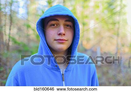 Stock Photograph - Caucasian teenage boy in forest. Fotosearch