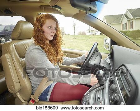 Stock Photo - Caucasian teenage girl driving car. Fotosearch
