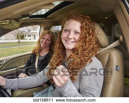 Caucasian teenage girl showing key with mother in car View Large Photo Image Stock Image - Caucasian teenage girl showing key with mother in car. Fotosearch