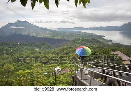 Stock Photo - Caucasian tourist admiring scenic view of jungle. Fotosearch