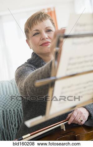 Caucasian violinist writing on sheet music View Large Photo Image Stock Photo - Caucasian violinist writing on sheet music. Fotosearch