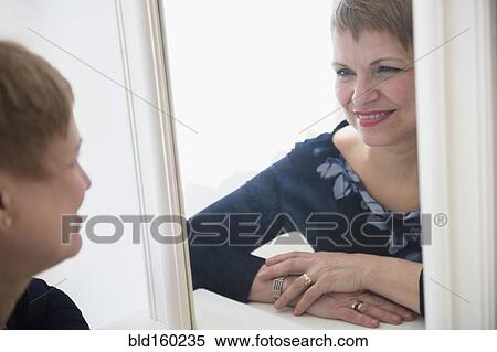 Caucasian woman admiring herself in mirror View Large Photo Image Stock Photography - Caucasian woman admiring herself in mirror. Fotosearch