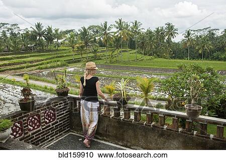 Caucasian woman admiring rural farm fields from rooftop View Large Photo Image Stock Image - Caucasian woman admiring rural farm fields from rooftop. Fotosearch