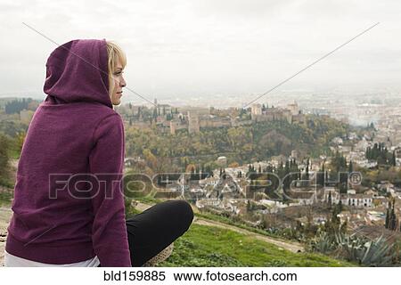 Stock Photography - Caucasian woman admiring scenic view of cityscape, Granada, Spain. Fotosearch