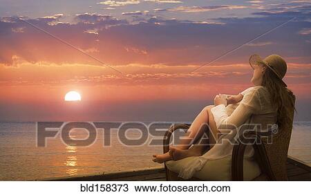 Caucasian woman admiring sunset on beach View Large Photo Image Stock Image - Caucasian woman admiring sunset on beach. Fotosearch