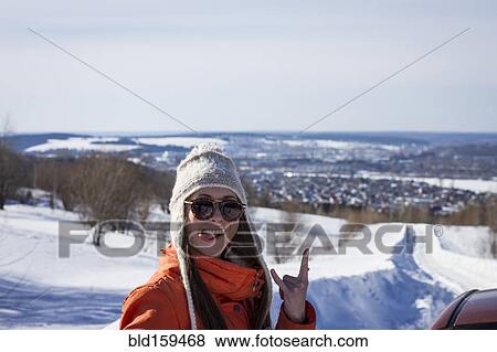 Stock Photo - Caucasian woman gesturing on snowy road. Fotosearch